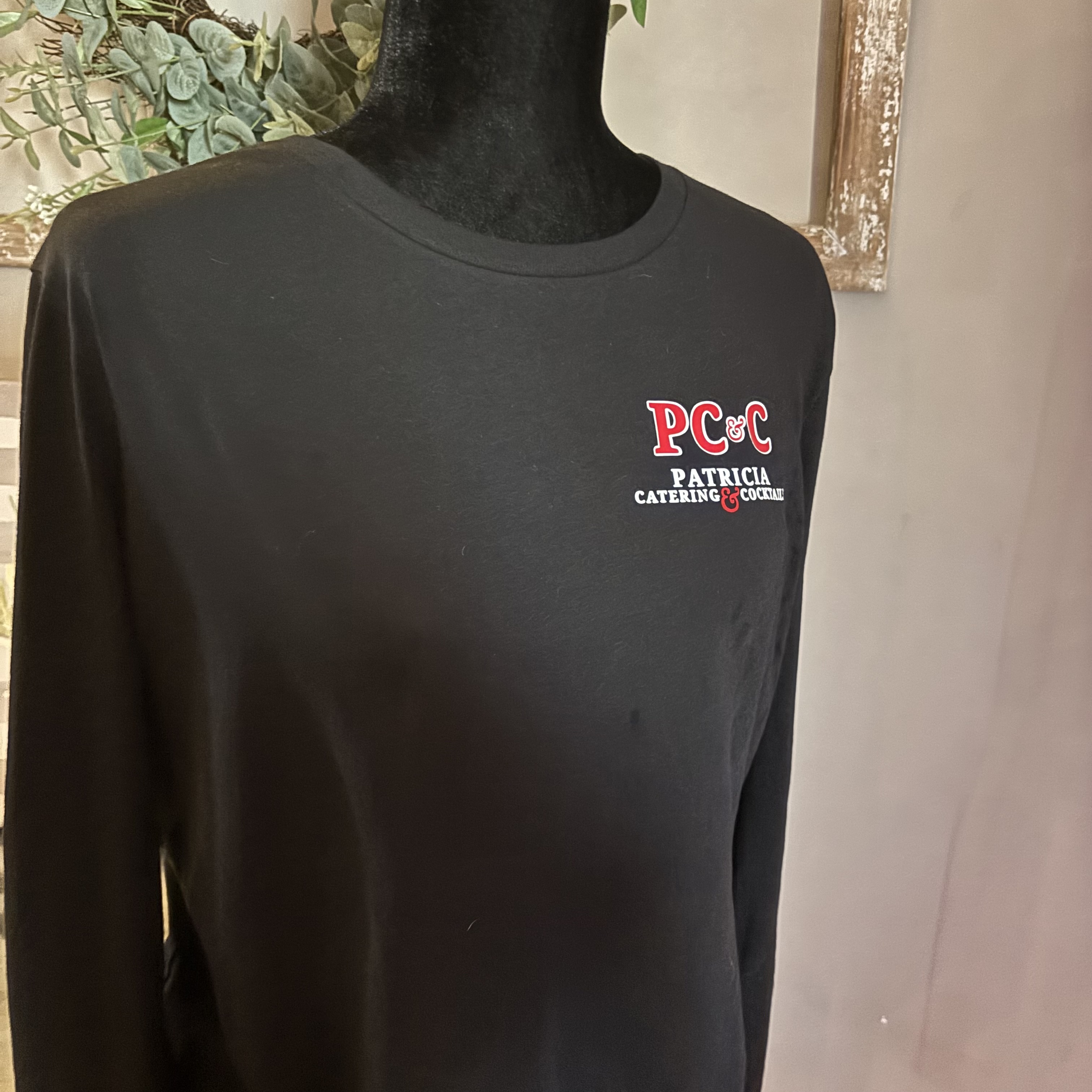 Black Patricia Catering & Cocktails long-sleeve crewneck on a mannequin