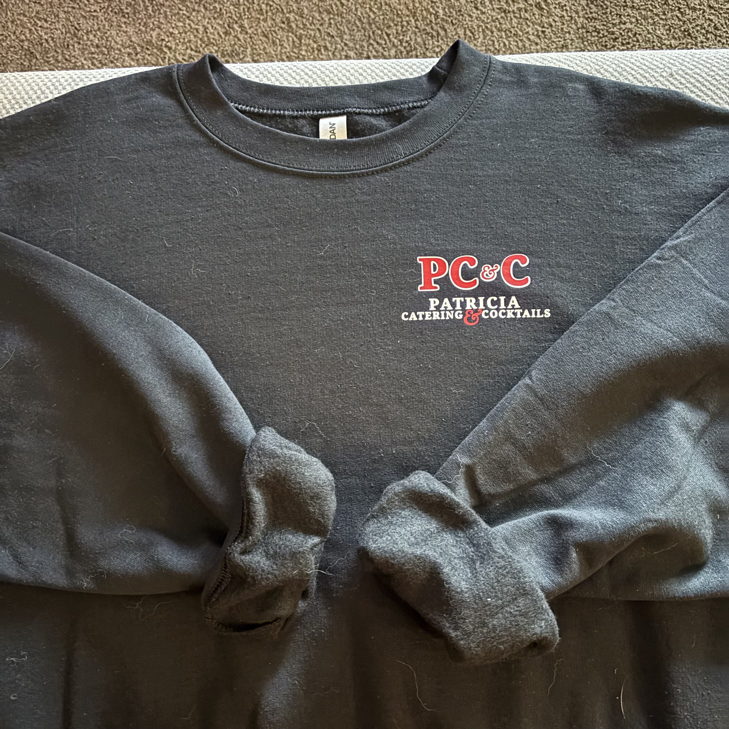 Charcoal Patricia Catering & Cocktails crewneck sweatshirt laid flat